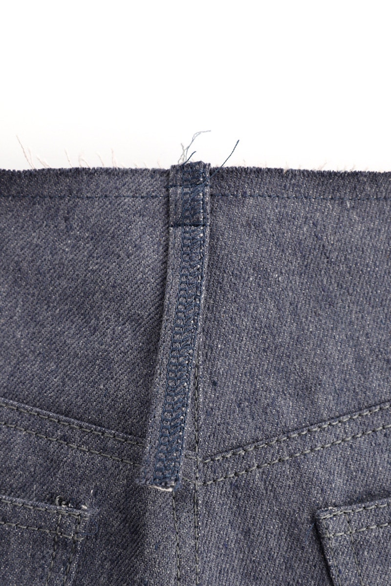 22 belt loops back sewn close