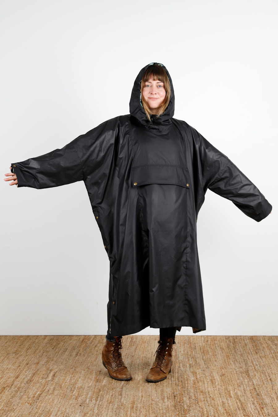 Becca Assembly Line Hoodie Poncho Black Front Hood Up Arms Out
